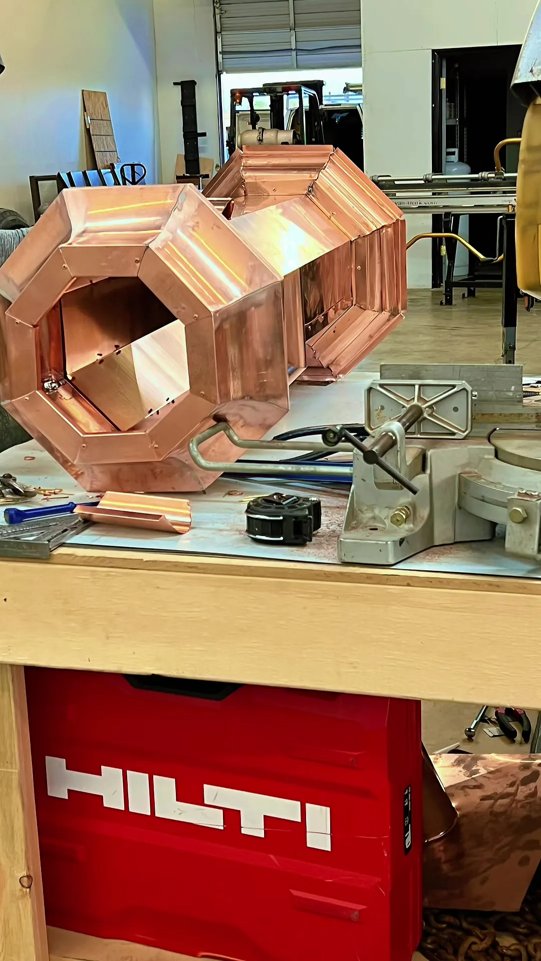 Large octagonal copper collector head, newly soldered, on a workbench in the shop